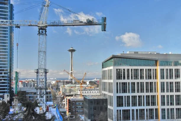 Seattle skyline with cranes and buildings under construction.